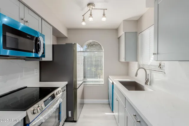 a kitchen that has a sink and a stove in it
