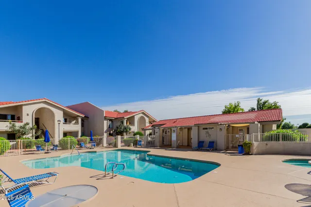 a view of swimming pool with outdoor seating and a yard
