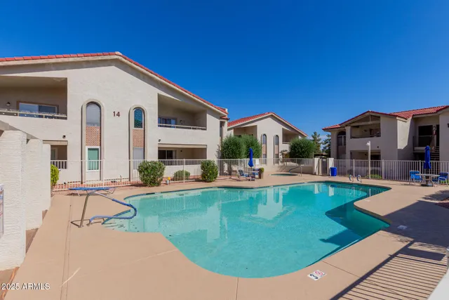 a view of a house with swimming pool and sitting area