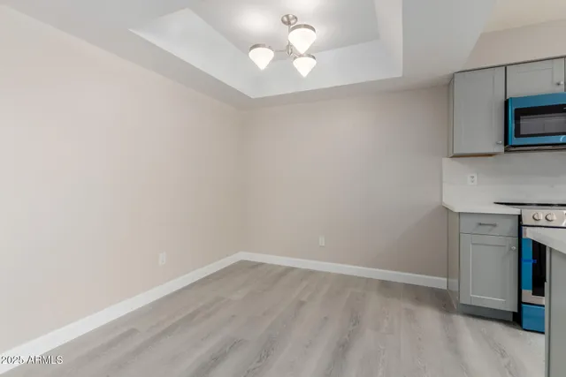 a view of kitchen with sink and microwave