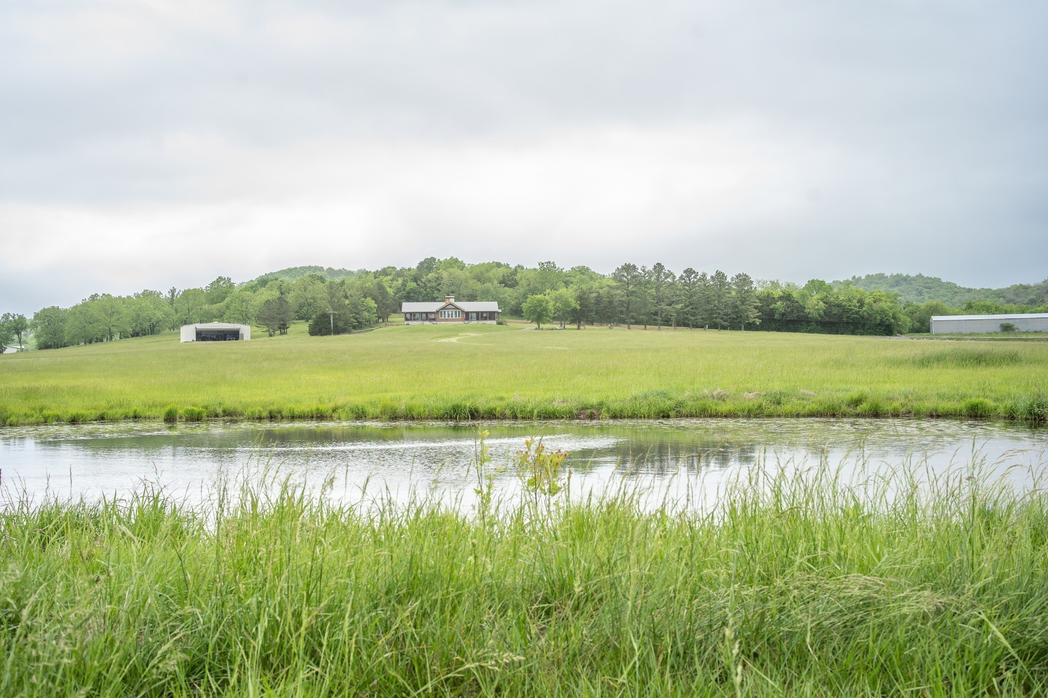 521 Coop Road Bell Buckle, TN 37020 - Photo 2 of 63 a view of a lake with houses in the back