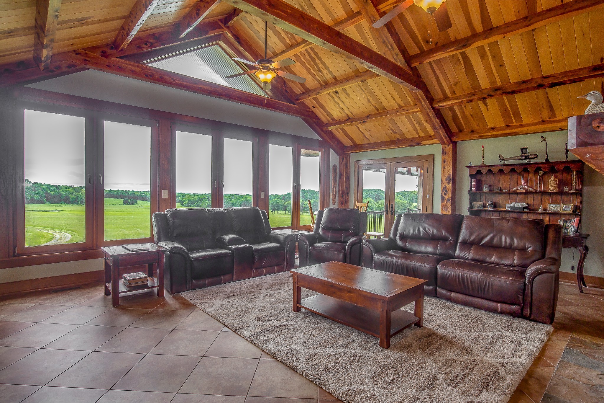 521 Coop Road Bell Buckle, TN 37020 - Photo 33 of 63 a living room with furniture a flat screen tv and floor to ceiling windows