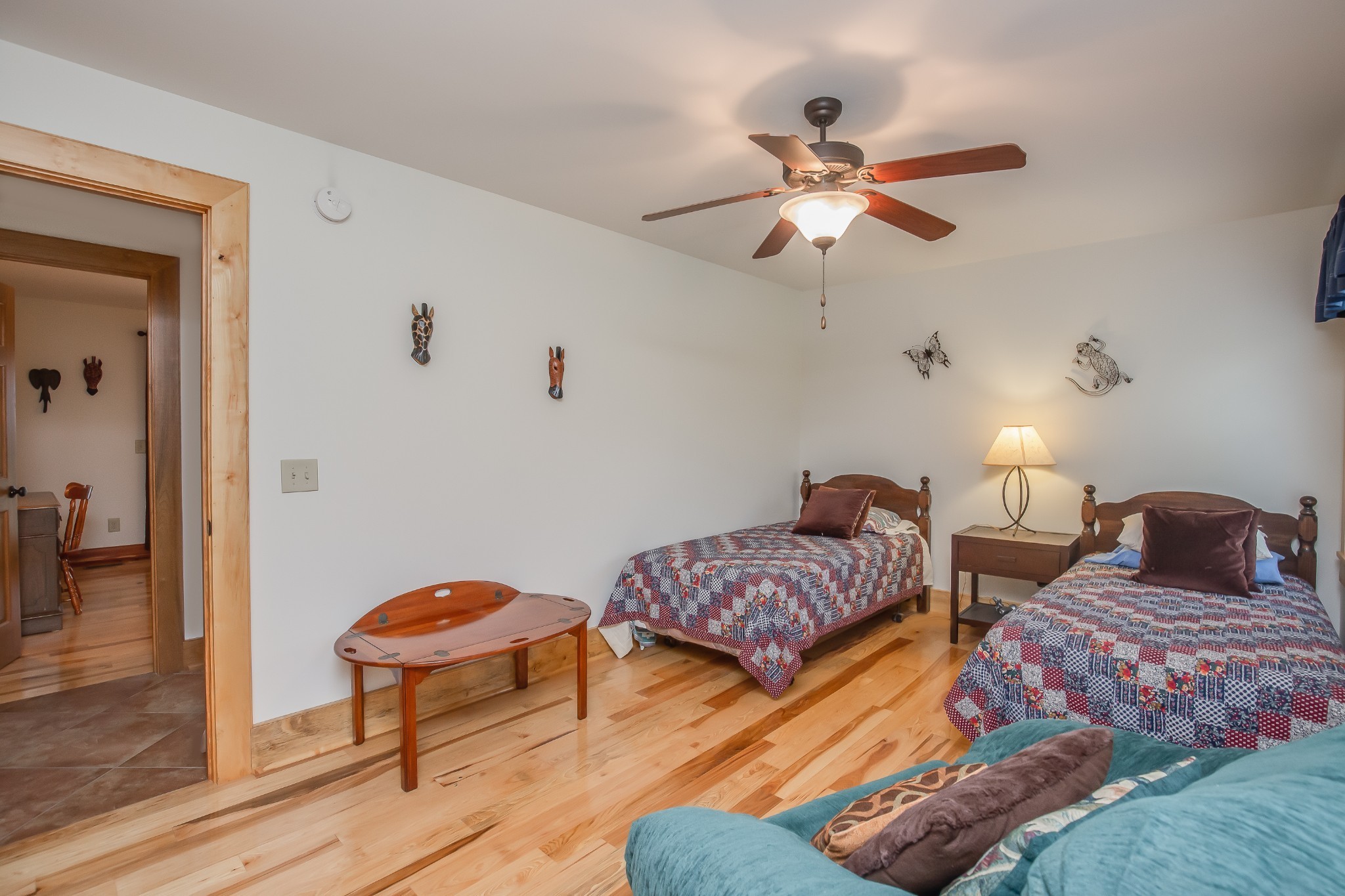 521 Coop Road Bell Buckle, TN 37020 - Photo 43 of 63 a bedroom with two beds and a chandelier