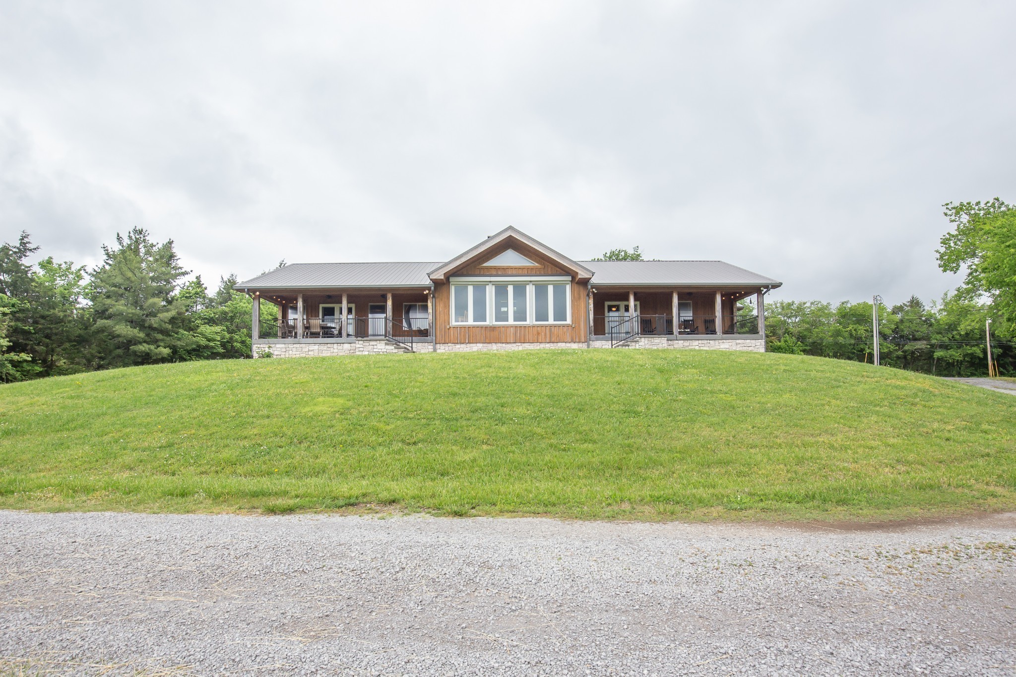 521 Coop Road Bell Buckle, TN 37020 - Photo 6 of 63 a view of a house next to a big yard with large trees