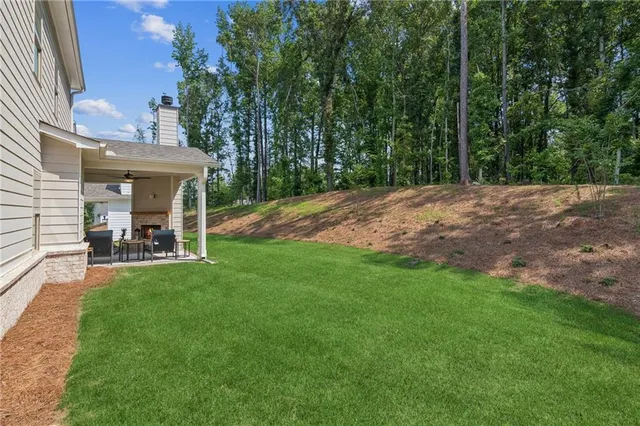 a view of a house with backyard and sitting area