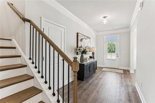 a view of an entryway with wooden floor and stairs