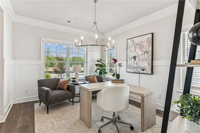 a dining room with furniture a chandelier and window