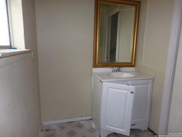 a bathroom with a sink and a mirror