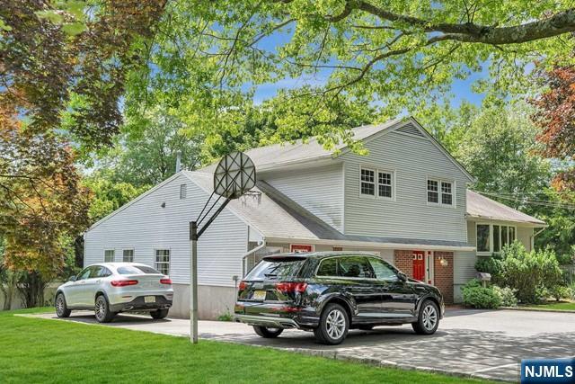 516 Knickerbocker Road Cresskill, NJ 07626 - Photo 26 of 31 a car parked in front of white house