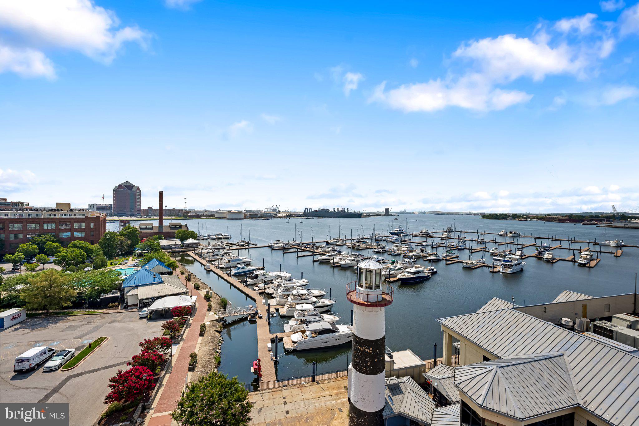 2702 Lighthouse Point East, Unit 738 Baltimore, MD 21224 - Photo 19 of 33 Scenic marina with vibrant skyline.