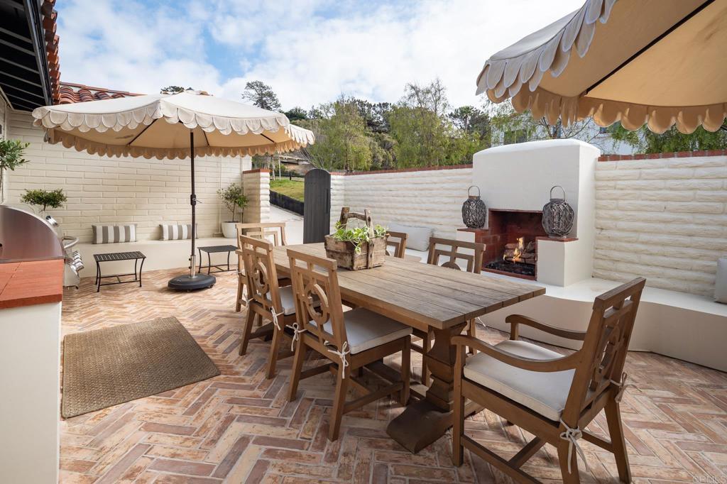1935 Santa Fe Avenue Del Mar, CA 92014 - Photo 1 of 42 a view of a patio with a dining table and chairs under an umbrella