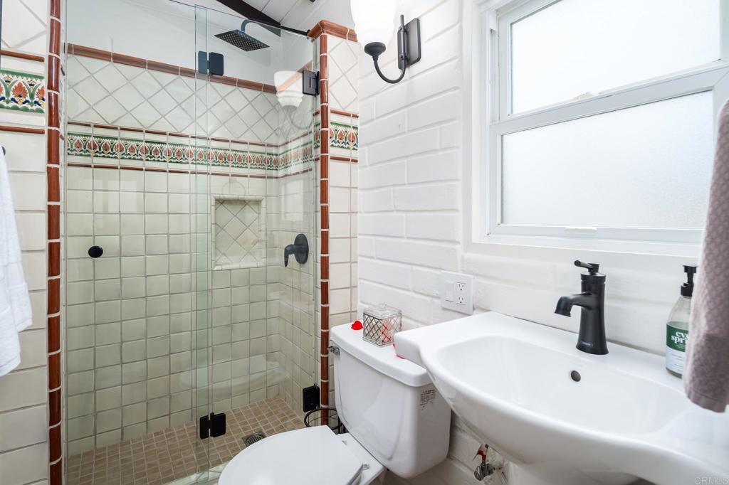 1935 Santa Fe Avenue Del Mar, CA 92014 - Photo 14 of 42 a bathroom with a sink and mirror with toilet