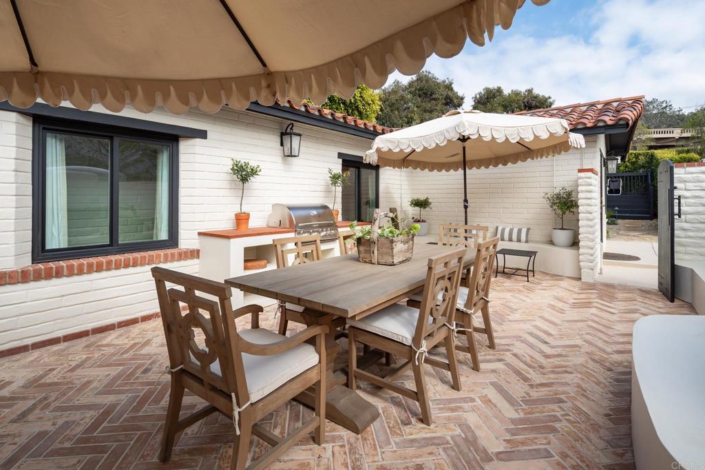 1935 Santa Fe Avenue Del Mar, CA 92014 - Photo 19 of 42 a view of a patio with a dining table and chairs under an umbrella