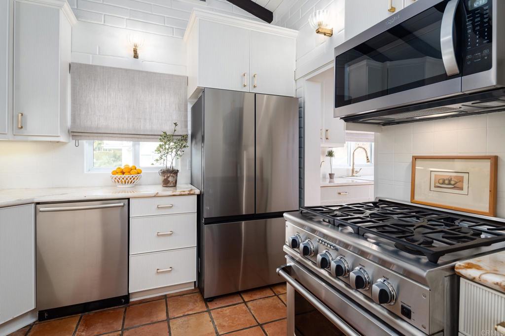 1935 Santa Fe Avenue Del Mar, CA 92014 - Photo 8 of 42 a kitchen with stainless steel appliances granite countertop a stove and a refrigerator