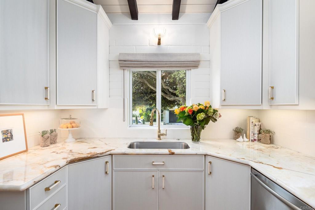 1935 Santa Fe Avenue Del Mar, CA 92014 - Photo 9 of 42 a kitchen with stainless steel appliances granite countertop a sink a window and white cabinets