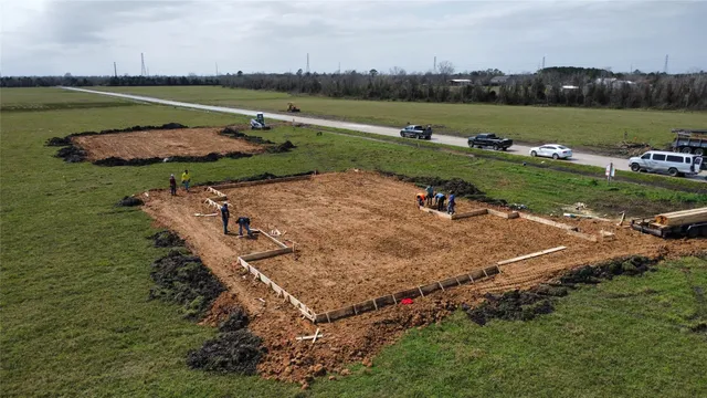an aerial view of a house with a yard and lake view
