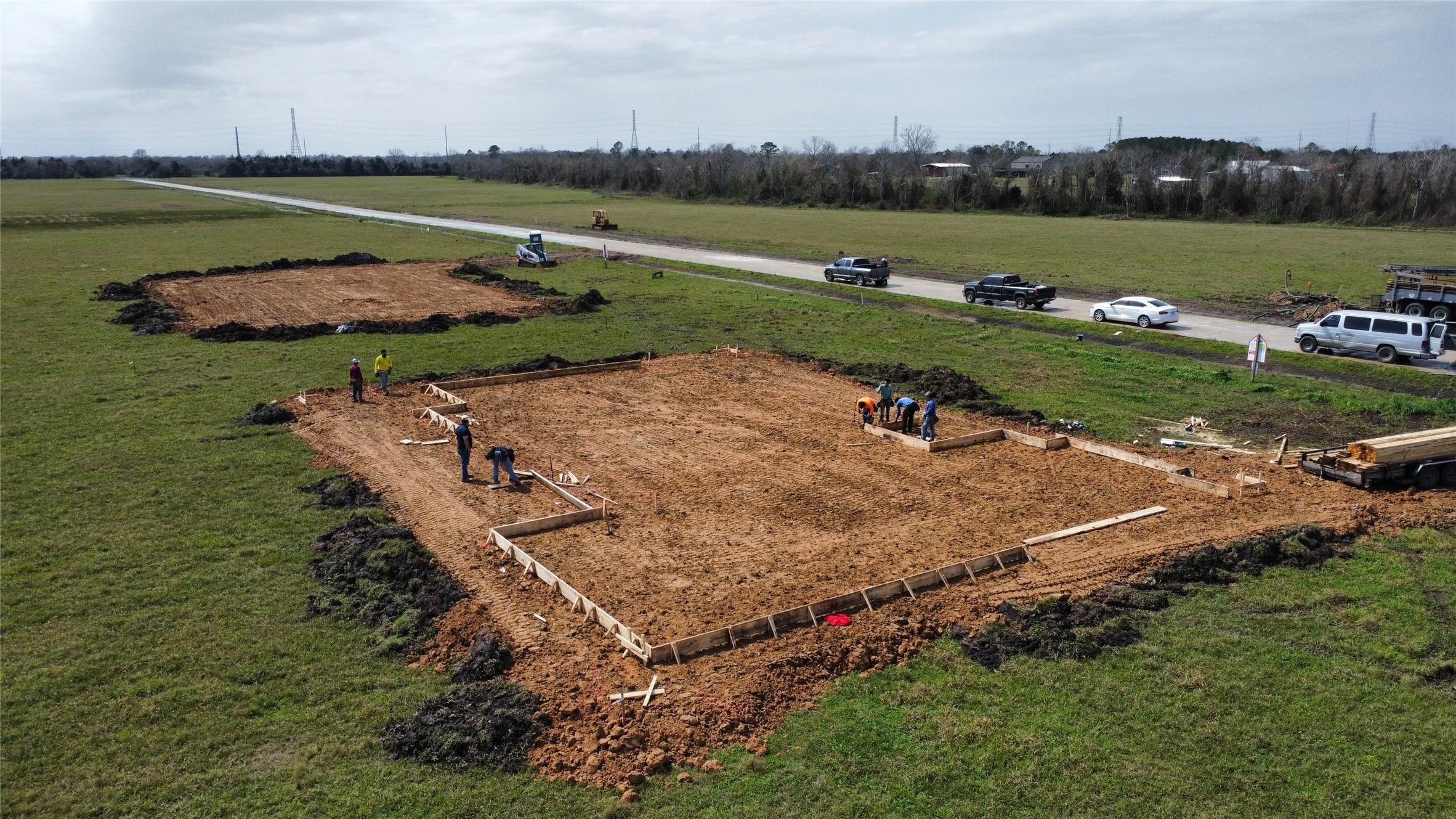 an aerial view of a house with a yard and lake view