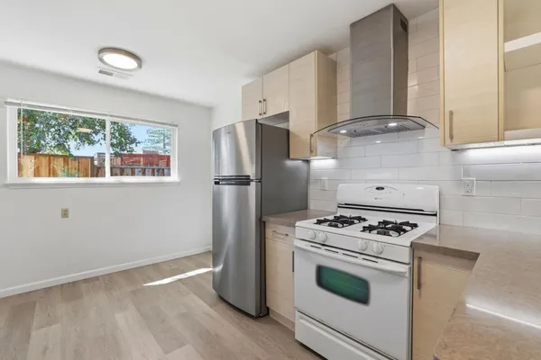 a kitchen with granite countertop a stove and a refrigerator