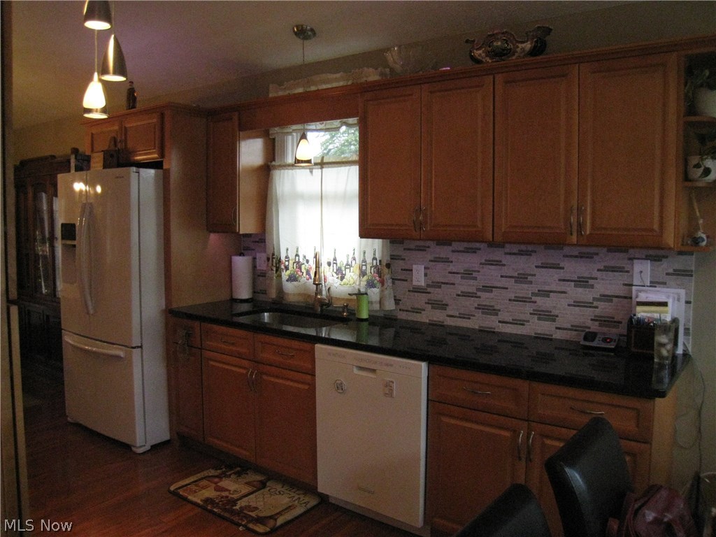 8087 Munson Road Mentor, OH 44060 - Photo 12 of 23 Special lighting above and underneath cabinets, a remote to change the colors. Granite counter tops and glass tile back splash. Wood laminate floor.