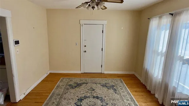 a view of hallway with a rug and a carpet