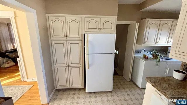 a kitchen with refrigerator a stove a microwave and cabinets