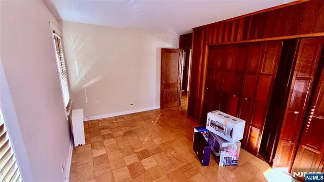 a view of an empty room with wooden walls