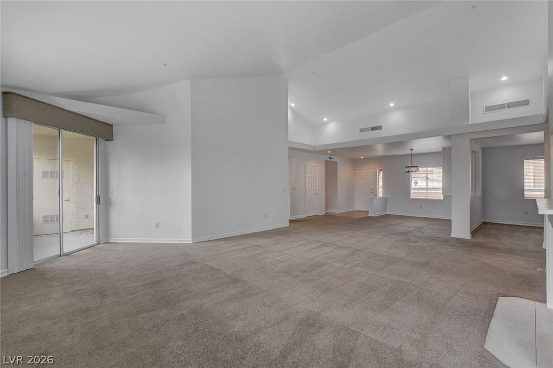 230 East Flamingo Road, Unit 404 Las Vegas, NV 89169 - Photo 5 of 34 Vaulted ceilings and soft carpeting enhance the open, airy flow of this inviting interior.