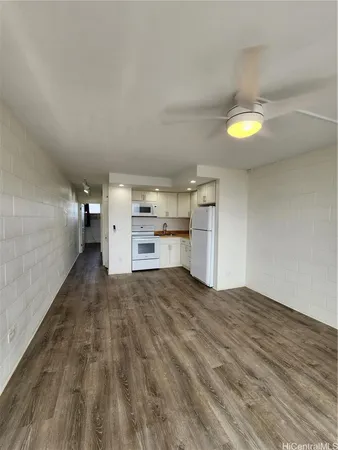 a view of a kitchen with a sink and a refrigerator