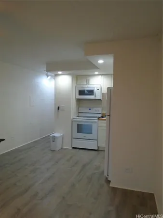 a view of a kitchen with a sink refrigerator and cabinets
