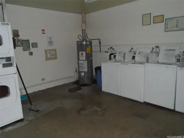 a view of storage and utility room with two washing machine