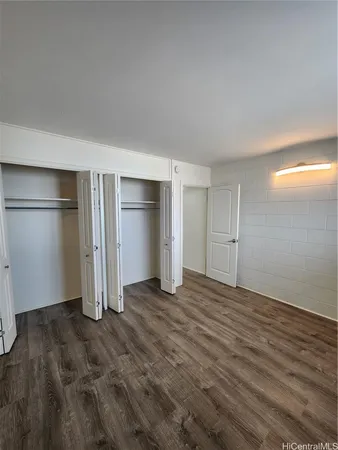 a view of an empty room with closet area