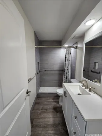 a bathroom with a double vanity sink a toilet and a mirror