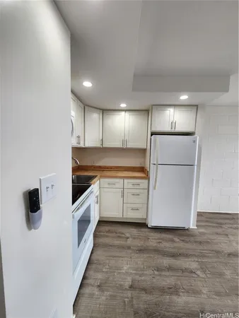 a kitchen with a refrigerator and a stove
