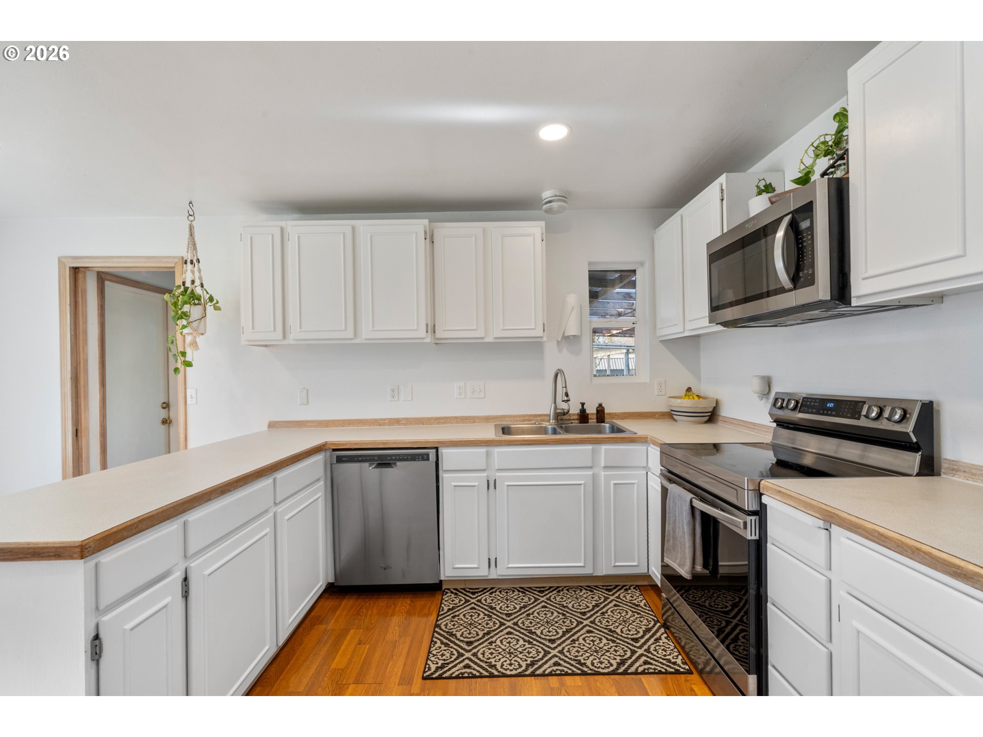 3500 Hawthorne Lane Tillamook, OR 97141 - Photo 12 of 35 a kitchen with stainless steel appliances granite countertop a stove a sink and a microwave
