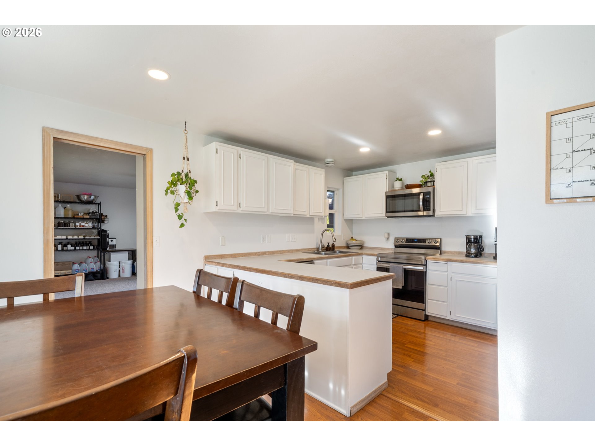 3500 Hawthorne Lane Tillamook, OR 97141 - Photo 8 of 35 a kitchen with stainless steel appliances granite countertop a stove a refrigerator a sink a stove and white cabinets with wooden floor