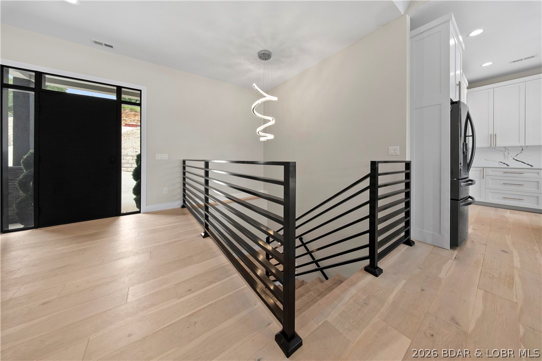 439 Red Bud Road Lake Ozark, MO 65049 - Photo 10 of 98 Expansive entryway with modern staircase and clean
