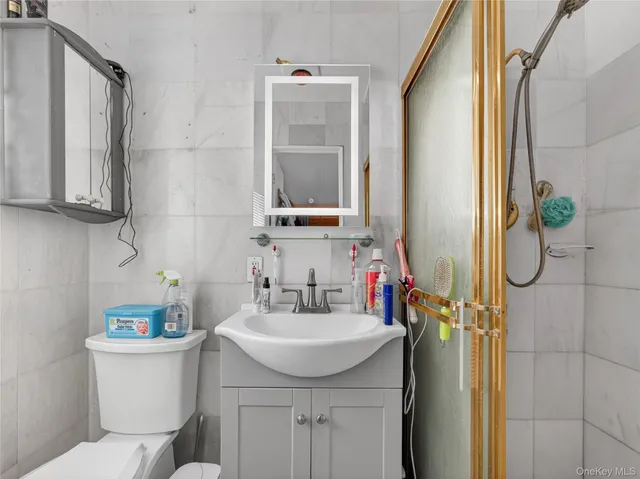 a bathroom with a sink a toilet and shower curtain