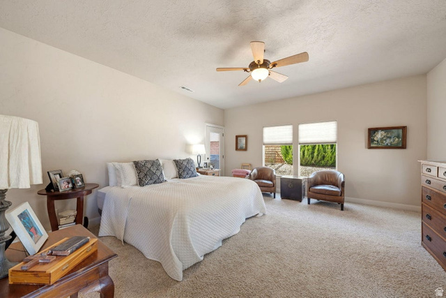1609 East 10 S Street St. George, UT 84790 - Photo 27 of 68 Spacious bedroom featuring neutral carpeting, a ceiling fan with integrated lighting, and two large windows allowing for ample natural light