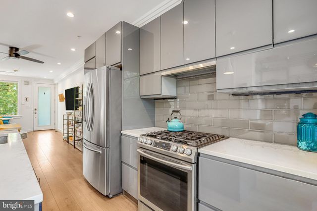 a kitchen with a stove a refrigerator and a sink