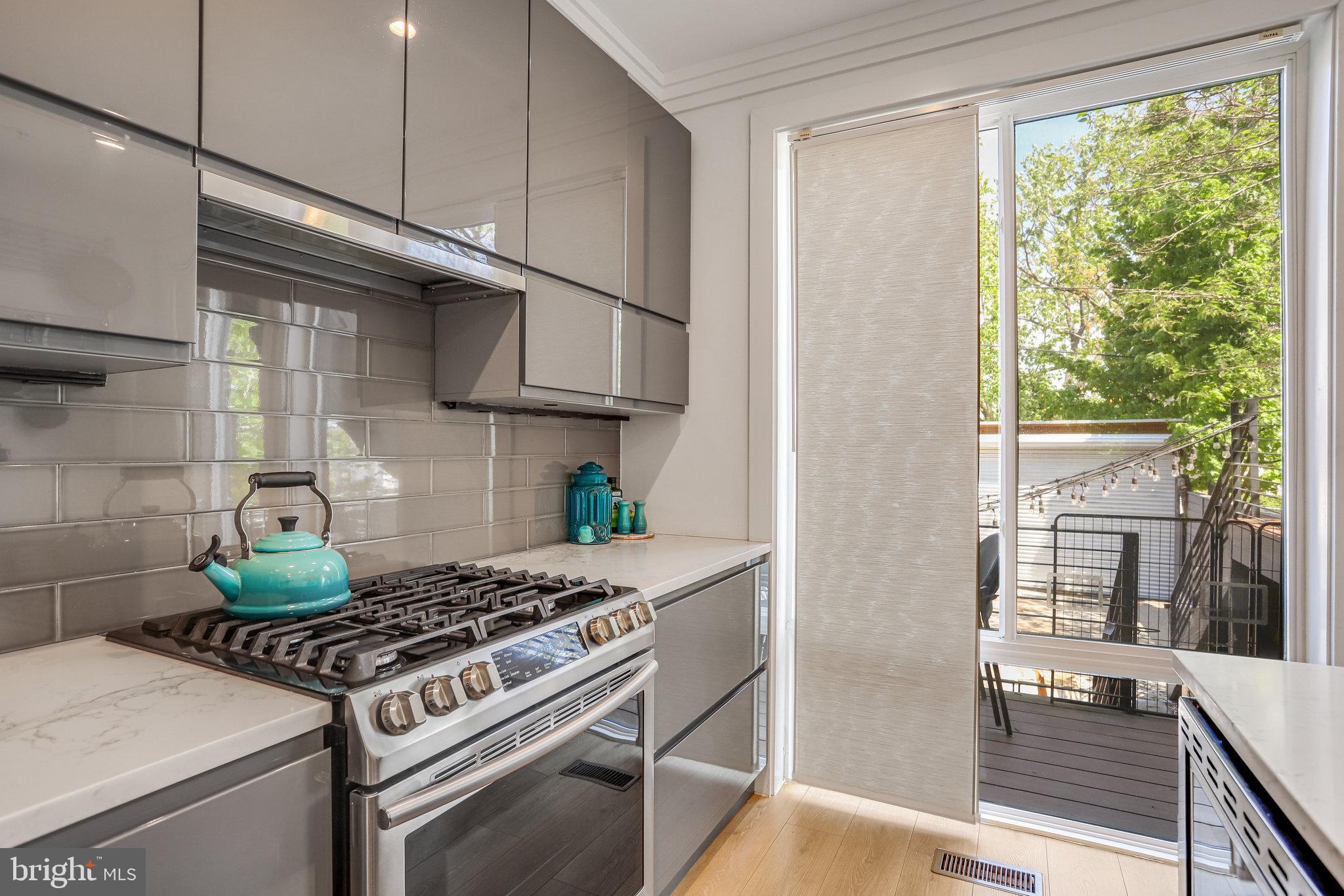 308 U Street Northeast, Unit 1 Washington, DC 20002 - Photo 12 of 25 a kitchen with stainless steel appliances granite countertop a stove and a refrigerator