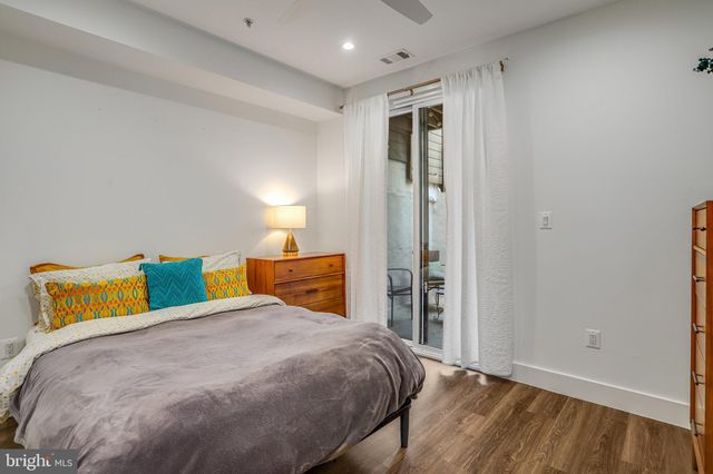 a bedroom with a bed and a night stand