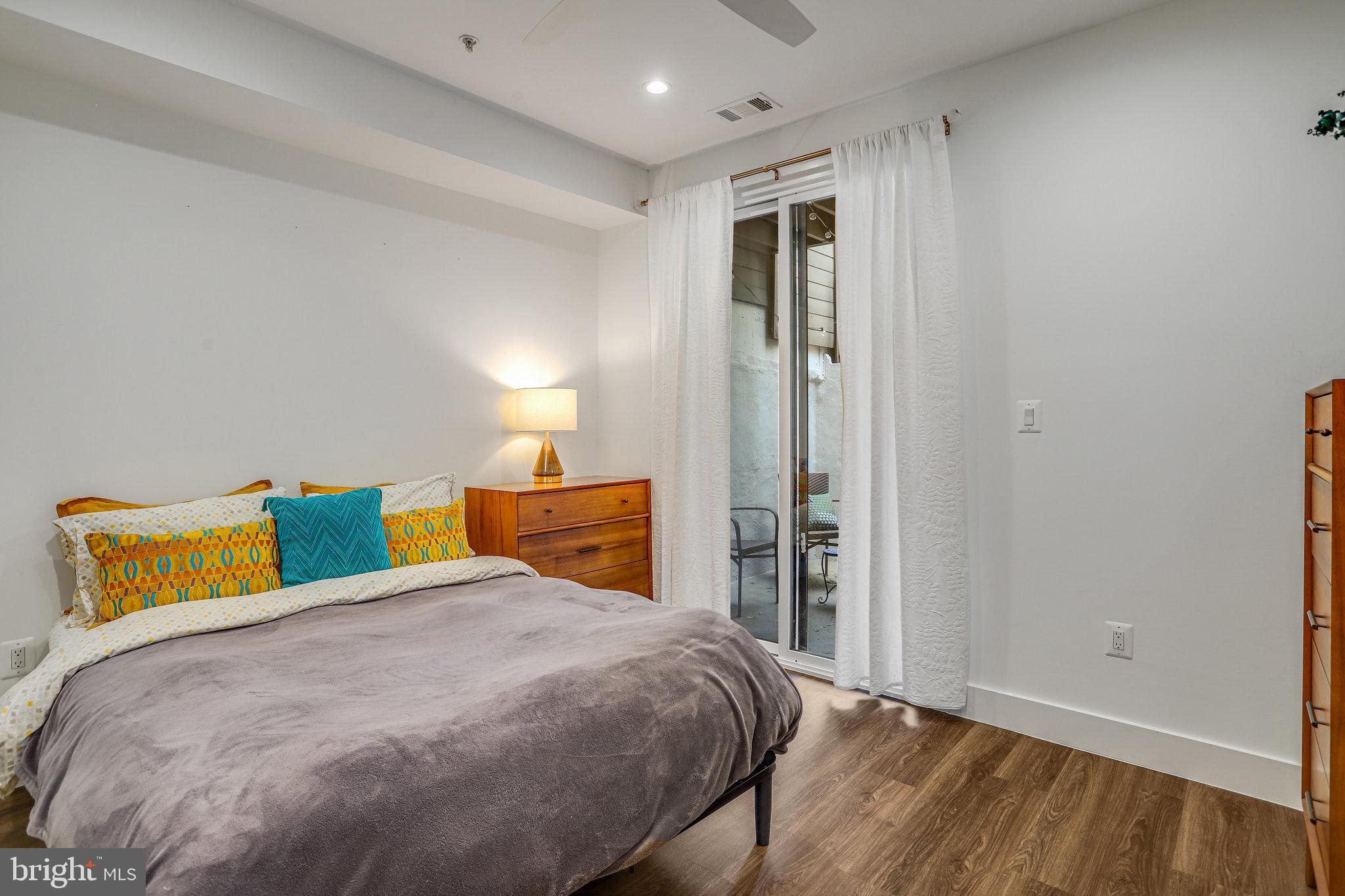 308 U Street Northeast, Unit 1 Washington, DC 20002 - Photo 18 of 25 a bedroom with a bed and a night stand