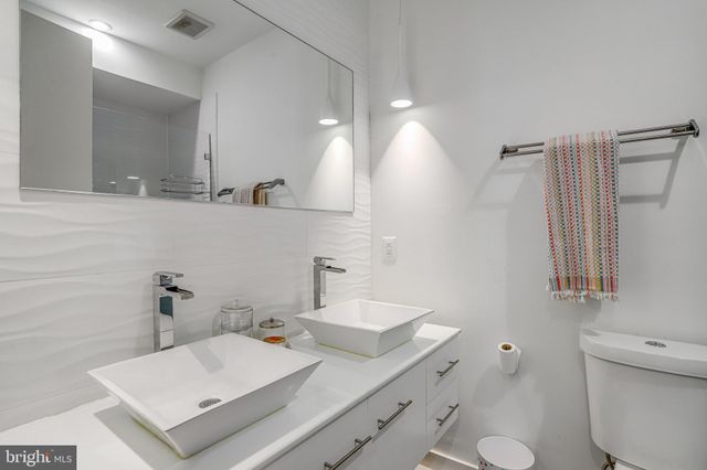 a bathroom with a sink toilet and mirror