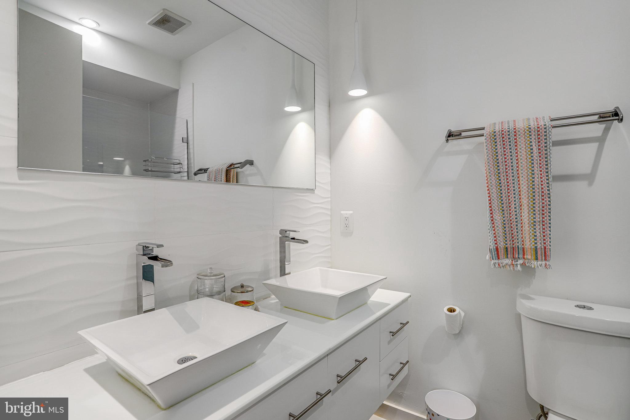 308 U Street Northeast, Unit 1 Washington, DC 20002 - Photo 21 of 25 a bathroom with a sink toilet and mirror