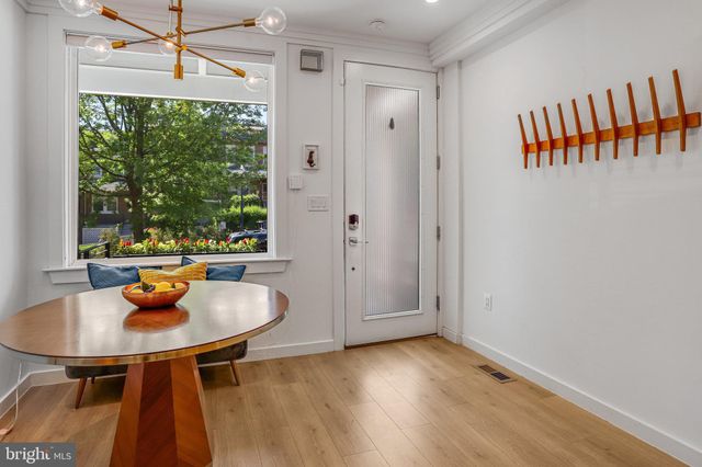 a dining room with furniture and a window