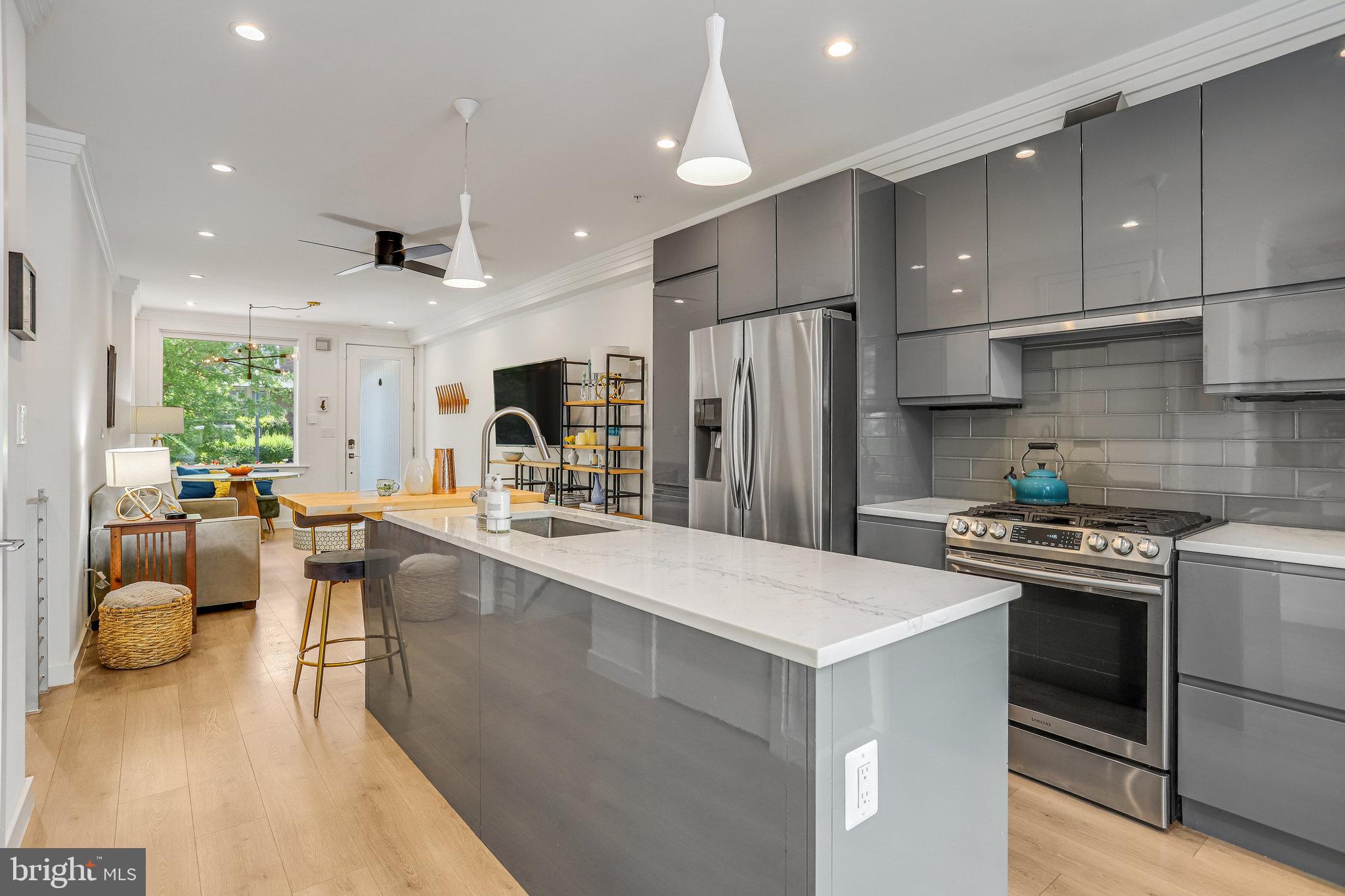 308 U Street Northeast, Unit 1 Washington, DC 20002 - Photo 10 of 25 a kitchen with sink a refrigerator and chairs