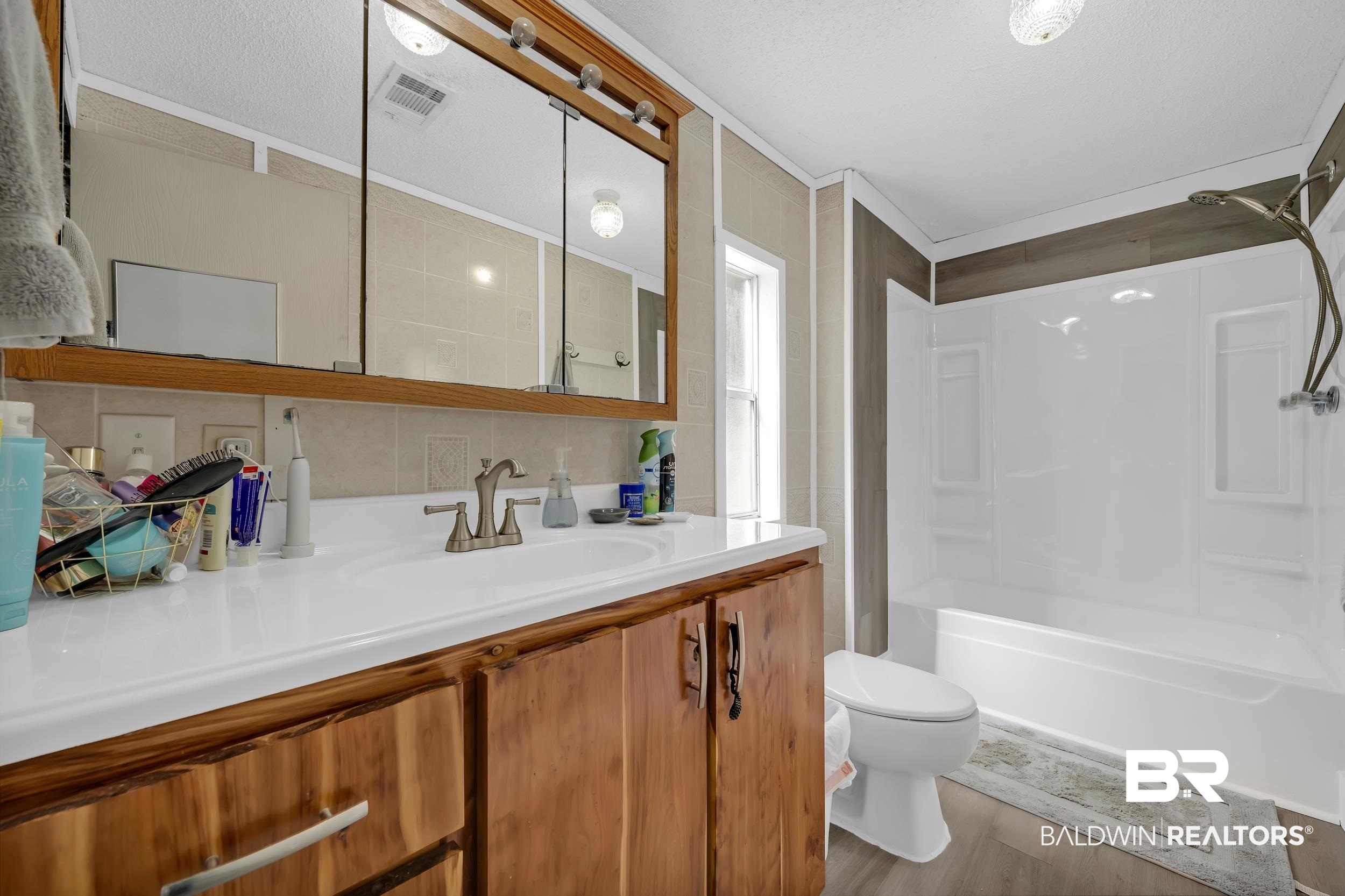22823 Lanier Road Robertsdale, AL 36567 - Photo 44 of 46 Full bath featuring light wood finished floors, vanity, and tub / shower combination