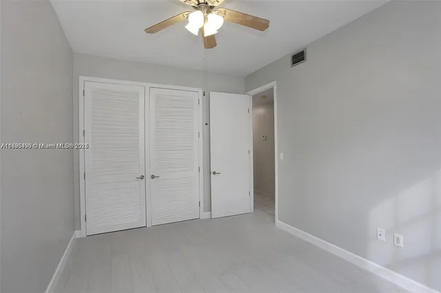 an empty room with a chandelier fan