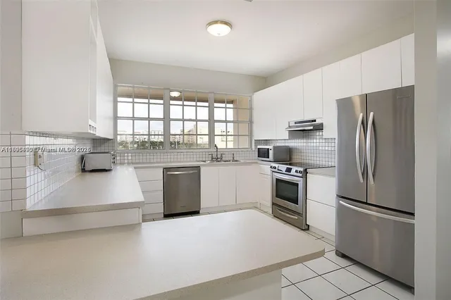 a kitchen with a refrigerator sink and wooden floor