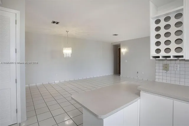 a view of a kitchen with granite countertop cabinets